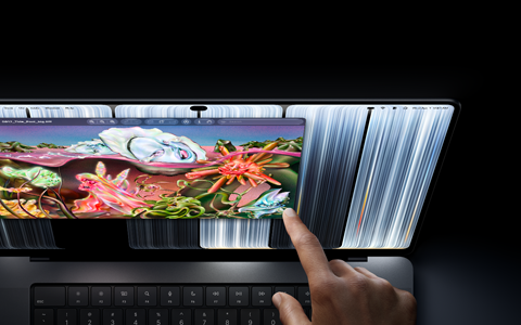 MacBook Pro with PROLED XDR Display, space black color, user resizes a window on screen with their fingertip